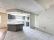 Kitchen with gray cabinets, breakfast bar, and white countertops at 7337 Cone Shell Dr, Spring Hill, FL 34607