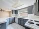 Kitchen featuring gray cabinets, white countertops, and standard appliances at 7337 Cone Shell Dr, Spring Hill, FL 34607