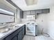 Traditional style kitchen with gray cabinets and double sink at 7337 Cone Shell Dr, Spring Hill, FL 34607