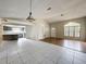 Open-concept living room with gray tile, wood flooring, and adjacent kitchen at 7337 Cone Shell Dr, Spring Hill, FL 34607