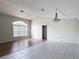 Neutral living room with combined tile and hardwood floors, vaulted ceiling, and natural lighting at 7337 Cone Shell Dr, Spring Hill, FL 34607