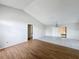 Spacious living room with wood and tile flooring, sliding glass doors, and neutral colored walls at 7337 Cone Shell Dr, Spring Hill, FL 34607