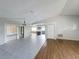 Open-concept living space with tile and wood flooring, neutral walls, and kitchen views at 7337 Cone Shell Dr, Spring Hill, FL 34607