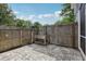 Backyard patio featuring brick pavers, a wooden fence and a garden planter at 2731 Penzance St, Palm Harbor, FL 34684