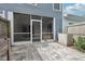 Fenced backyard with a screened lanai and a paved patio with wooden planters at 2731 Penzance St, Palm Harbor, FL 34684