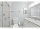 Bright bathroom with granite countertop vanity, shower, and modern fixtures at 2731 Penzance St, Palm Harbor, FL 34684