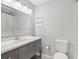 Well-lit bathroom with a large vanity, shower/tub, and toilet at 2731 Penzance St, Palm Harbor, FL 34684