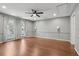 Bedroom featuring neutral paint, hardwood floors, ceiling fan, and large windows at 2731 Penzance St, Palm Harbor, FL 34684