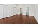 Bright bedroom with hardwood floors, dual closets, and an ensuite bathroom at 2731 Penzance St, Palm Harbor, FL 34684