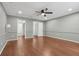 Bedroom with hardwood floors, ceiling fan, and adjacent bathroom at 2731 Penzance St, Palm Harbor, FL 34684