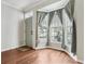 Cozy entryway with wood floors and a view to the outside from a large bay window at 2731 Penzance St, Palm Harbor, FL 34684
