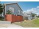 Exterior view of a blue two-story house with a fenced yard at 2731 Penzance St, Palm Harbor, FL 34684