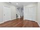 Hallway with wood floors leading to staircase, door, and closet at 2731 Penzance St, Palm Harbor, FL 34684