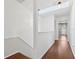 Upstairs hallway with hardwood floors, skylight, and pendant lighting at 2731 Penzance St, Palm Harbor, FL 34684