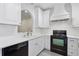 Modern kitchen with stainless steel appliances, white cabinets, and a subway tile backsplash at 2731 Penzance St, Palm Harbor, FL 34684