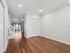 Open-concept living room with wood floors, stairs, and bay window at 2731 Penzance St, Palm Harbor, FL 34684