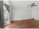 Bright living room with wood floors, ceiling fan, and natural light from a large window at 2731 Penzance St, Palm Harbor, FL 34684