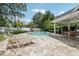 Community pool featuring lounge chairs and shaded patio area at 2731 Penzance St, Palm Harbor, FL 34684
