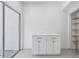 Bright room featuring modern white cabinetry, slider doors to the patio, and access to walk-in shelving at 2731 Penzance St, Palm Harbor, FL 34684