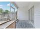 Covered and screened porch with patterned floor and view of the fenced yard at 2731 Penzance St, Palm Harbor, FL 34684