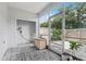 Screened porch with tile floor, wooden cabinet and utility hook-ups at 2731 Penzance St, Palm Harbor, FL 34684
