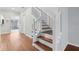 Staircase featuring a hardwood floor and white banister at 2731 Penzance St, Palm Harbor, FL 34684