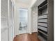 Walk-in closet with custom shelving and access to an adjoining bathroom at 2731 Penzance St, Palm Harbor, FL 34684