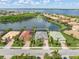 The aerial view showcases the property's proximity to a serene lake and its desirable location within a vibrant community at 13064 N Marsh Dr, Port Charlotte, FL 33953