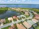 An aerial perspective reveals the community's layout, highlighting its proximity to a large lake and lush greenery at 13064 N Marsh Dr, Port Charlotte, FL 33953