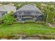 The aerial view showcases the enclosed pool and lanai, surrounded by lush landscaping, providing a private outdoor oasis at 13064 N Marsh Dr, Port Charlotte, FL 33953