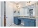 Bathroom featuring double vanities, granite countertops, and elegant lighting fixtures at 13064 N Marsh Dr, Port Charlotte, FL 33953