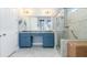 Beautiful bathroom with blue vanity, granite countertops, and a glass enclosed shower at 13064 N Marsh Dr, Port Charlotte, FL 33953