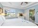 Bright bedroom with neutral decor, tray ceiling and access to the lanai at 13064 N Marsh Dr, Port Charlotte, FL 33953