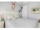This cozy bedroom features a deer head, neutral paint and décor, and a white queen-sized bed at 13064 N Marsh Dr, Port Charlotte, FL 33953
