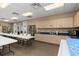 Spacious craft room featuring ample counter space, sinks, and a large table for various activities at 13064 N Marsh Dr, Port Charlotte, FL 33953