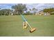 Spacious croquet field with lush green grass, ready for a friendly match in a picturesque setting at 13064 N Marsh Dr, Port Charlotte, FL 33953