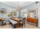 Light-filled dining room showcases plantation shutters, rustic table, and stylish decor at 13064 N Marsh Dr, Port Charlotte, FL 33953