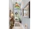 The bright foyer features tile floors, high ceilings, and custom paint and decor at 13064 N Marsh Dr, Port Charlotte, FL 33953