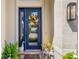 A lovely front door with glass insert, wreath, and seasonal decorations adorn this home's entryway at 13064 N Marsh Dr, Port Charlotte, FL 33953