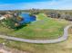 Scenic aerial view of a pristine golf course with lush green fairways and a serene lake at 13064 N Marsh Dr, Port Charlotte, FL 33953