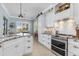 Bright kitchen featuring white cabinetry, granite countertops, and stainless steel appliances at 13064 N Marsh Dr, Port Charlotte, FL 33953
