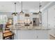 Spacious kitchen with an island and barstool seating, featuring stainless steel appliances and custom cabinetry at 13064 N Marsh Dr, Port Charlotte, FL 33953