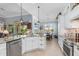 Bright and airy kitchen featuring stainless steel appliances, island seating, and a view of the outdoor lanai at 13064 N Marsh Dr, Port Charlotte, FL 33953