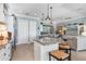Open kitchen boasts a spacious island, stainless steel appliances, and seamless flow into the living area at 13064 N Marsh Dr, Port Charlotte, FL 33953