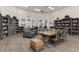 Inviting library with bookshelves, comfortable seating, and a large table for reading at 13064 N Marsh Dr, Port Charlotte, FL 33953