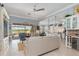 Open concept living space flows to the kitchen featuring lots of natural light and views of the lake at 13064 N Marsh Dr, Port Charlotte, FL 33953