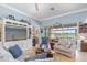 Comfortable living room with lake views through sliding glass doors, coastal decor, and plush seating at 13064 N Marsh Dr, Port Charlotte, FL 33953