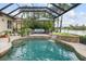The screened in pool with a waterfall offers a private outdoor oasis with lush landscaping and comfortable seating at 13064 N Marsh Dr, Port Charlotte, FL 33953