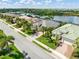 Charming street view showcasing well-manicured lawns, mature palm trees, and lovely homes with tile roofs at 13064 N Marsh Dr, Port Charlotte, FL 33953