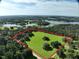 Aerial view of a spacious property surrounded by lush green trees, with large lakes nearby at 17380 Sweetwater Rd, Dade City, FL 33523